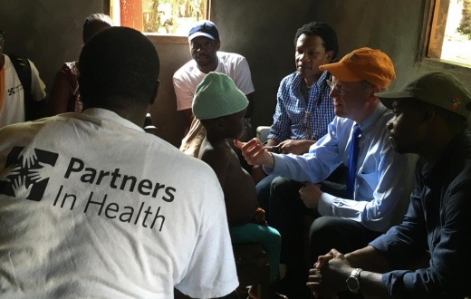 Dr. Paul Farmer examines an 8-year-old tuberculosis patient, during a home visit in Maryland County, Liberia.