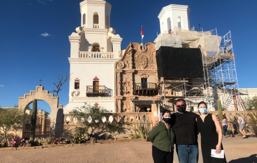 Manny Montano (center) stands in front of San Xavier del Bac Mission