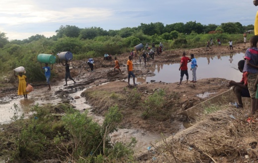 Cyclone Freddy victims in Chikwawa, Malawi, crossing the Namikalango River to seek shelter at a camp on the other side. 
