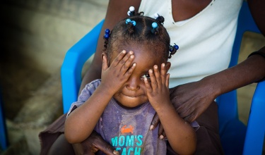 Lunie Lozama plays peek-a-boo. Lunie Lozama, a PIH malnutrition patient