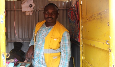Cancer survivor Bizinde Elyse runs a small shop near Butaro District Hospital 