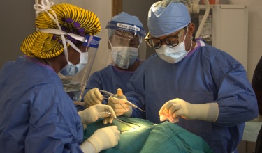 Dr. Gerald Ekwen, right, performs surgery at J.J. Dossen Hospital in Liberia Dr. Gerald Ekwen, right, performs surgery at J.J. Dossen Hospital in Liberia
