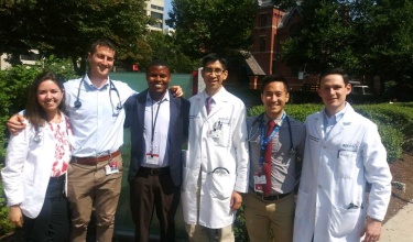 Heart surgery patient stands with medical colleagues outside BU's School of Medicine Heart surgery patient stands with medical colleagues outside BU's School of Medicine