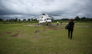 Sheila Davis walks to helicopter during Ebola response in Liberia