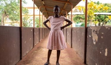 MDR-TB survivor poses outside hospital where she was cured