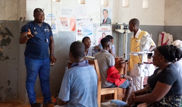 PIH clinician provides information to patients awaiting care