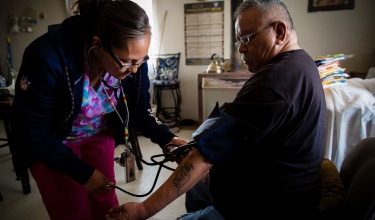 Community health representative on Navajo Nation takes patient's blood pressure