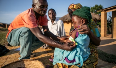 CHW Samuel Saidi checking for malnutrition in Kaingirira Village, Malawi
