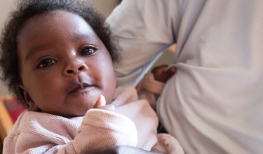 Tuyisenge Thacienne, 23, holds her daughter Nuioni Belise in Rwinkwavu, Rwanda