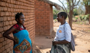 Eliza Kazembe and community health worker Grace Mgaiwa 