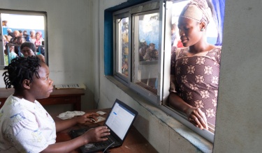 Abi Dauda registers for a checkup with Esther Ngaujah at Wellbody Clinic