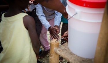 children wash hands during a cholera prevention campaign in Haiti
