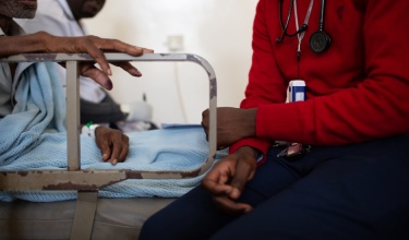 Nurse site on beside od patient