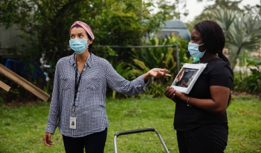 A health promoter giving an informational presentation about Covid-19 in Florida