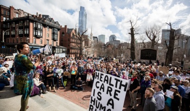 PIH Chief Medical Officer Dr. Joia Mukherjee speaks at a 2017 health care for all rally outside the Massachusetts State House