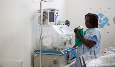 Thamar Julmiste feeding a newborn