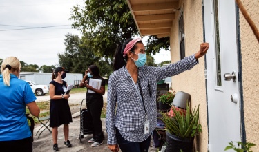 community health worker visits homes in Immokalee, Florida, to educate on COVID-19