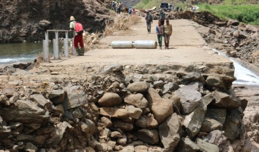 Community members walk on the crumbled Mants’onyane bridge in rural Lesotho 