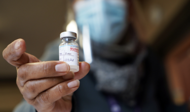 Toni K. Williams RN shows a vial