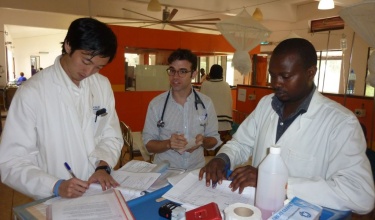 Dr. Paul Park, left, at work in Rwanda