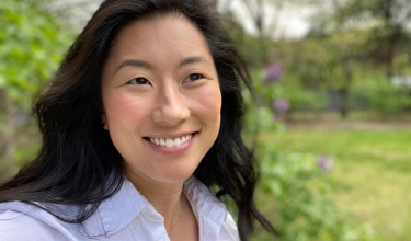 Megan Striplin, a lab program associate with PIH, smiles and looks off into the distance.