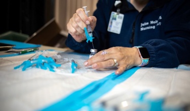 nurse prepares doses of COVID-19 vaccine in New Bedford, Massachusetts