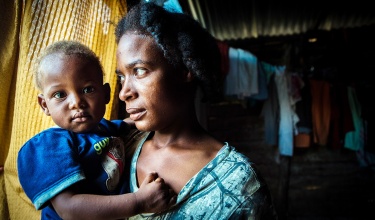 Mother hold child in arms