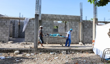Responders carry an injured person in Les Cayes, Haiti, on Aug. 15