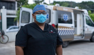 a paramedic stands for a portrait