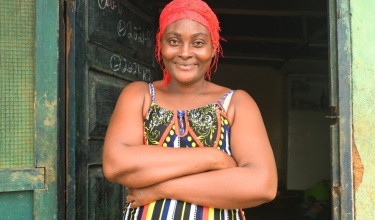 Ma-Kebbeh smiling while standing in a doorway