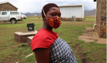 Limakatso Lerata stands near the maternal waiting home where she is staying in the weeks leading up to her delivery.