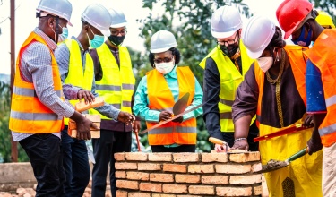 Leaders from PIH, the Rwandan government, and UGHE gather to break ground on the expansion of Butaro District Hospital.