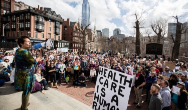 PIH Chief Medical Officer Dr. Joia Mukherjee speaks at a rally outside the Massachusetts State House speaking up in favor of access to health care for all in February 2017.