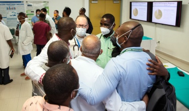 Dr. Paul Farmer speaks with clinicians at Hopital University de Mirebalais.