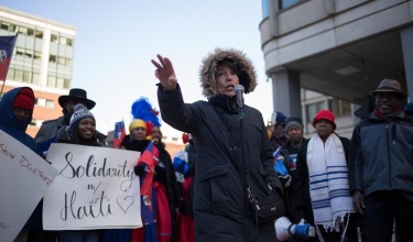 PIH Chief Medical Officer Dr. Joia Mukherjee speaks at a rally organized by Haitian-Americans United, calling for permanent residency status for TPS holders, and denouncing remarks made by then-President Trump.