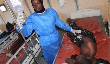Nurse Cephat Adam tends to 17-year-old cholera patient Enock Josephy, of Zalewa Village. Cholera treatment units are set up in a camp at Lisungwi Community Hospital in Malawi’s Neno District.