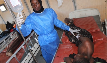 Nurse Cephat Adam tends to 17-year-old cholera patient Enock Josephy, of Zalewa Village. Cholera treatment units are set up in a camp at Lisungwi Community Hospital in Malawi’s Neno District. 