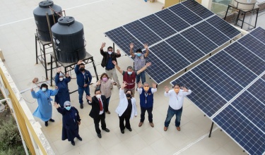 Socios En Salud staff stand with health workers in Yura, Arequipa, where solar panels were installed in March.