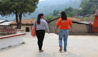 Mayra Ramirez (left), walks with a colleague from Compañeros En Salud, as Partners In Health is known in Mexico.