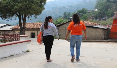 Mayra Ramirez (left), walks with a colleague from Compañeros En Salud, as Partners In Health is known in Mexico.
