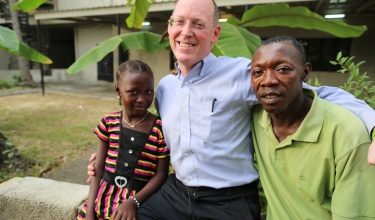 Dr. Paul Farmer visits Mariatu Sesay and her father, Sorie, during the 'Poverty Makes You Sick' campaign in Sierra Leone in 2015.