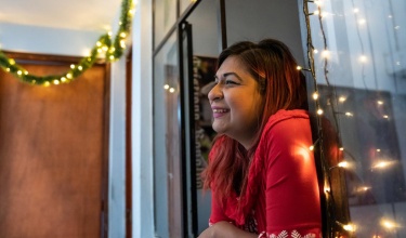 Brenda Mijahuanca looks out the window of her apartment in Lima, Peru.