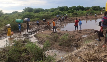 Cyclone Freddy victims in Chikwawa, Malawi, crossing the Namikalango River to seek shelter at a camp on the other side. 