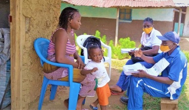 community health workers meet with patients