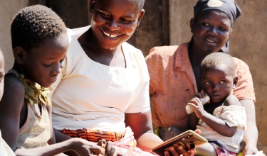 A community health worker visits a mother and her children in Malawi