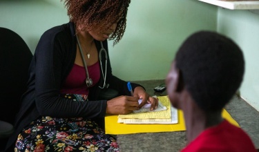 Mefa Sulani assists a patient living with HIV at Neno District Hospital in Malawi.