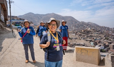 Delia Lunasco stands with community health workers in Carabayllo, Peru.