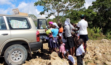 Residents of Jeannin in the area of St. Marc line up for food assistance from a Zanmi Lasante mobile clinic in Haiti.