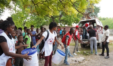 Relief workers loading emergency supplies into a vehicle
