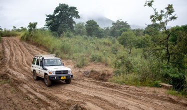 A team of health workers driving on rain damaged roads